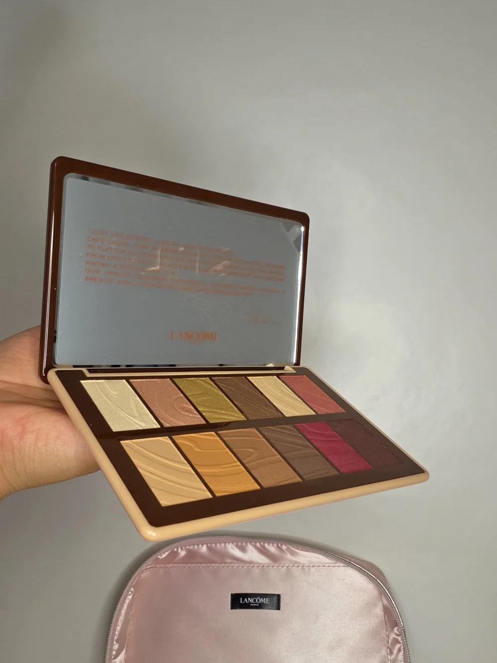 Lancome cute travel case for metallic pink makeup along with a palette of neutra
